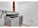 Clean laundry room with modern washer and dryer set at 13682 W Virginia Dr, Lakewood, CO 80228