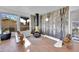 Sunlit living area with a unique fireplace and wood-paneled walls at 13682 W Virginia Dr, Lakewood, CO 80228