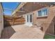 Brick-paved backyard, privacy fence, brick home, and patio doors create a cozy outdoor space at 610 S Xenon Ct, Lakewood, CO 80228