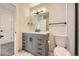 Renovated bathroom featuring modern vanity, quartz countertop, sleek fixtures, and marble tile floor at 610 S Xenon Ct, Lakewood, CO 80228