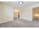 Spacious carpeted bedroom with neutral walls, base-molding, a large window, and modern ceiling fan at 610 S Xenon Ct, Lakewood, CO 80228