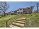Exterior of townhouse complex with landscaped lawn and stairs leading up to the property at 610 S Xenon Ct, Lakewood, CO 80228