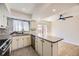 Bright kitchen features sleek countertops, stainless steel appliances, stylish backsplash, and access to the outdoor patio at 610 S Xenon Ct, Lakewood, CO 80228