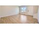 Well-lit living room featuring hardwood floors, a large window, and white trim at 610 S Xenon Ct, Lakewood, CO 80228