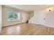 Spacious living room showcasing hardwood floors, a large window, and staircase access at 610 S Xenon Ct, Lakewood, CO 80228