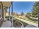 View from covered porch overlooking the grassy lawn and playground, showcasing the community amenities at 610 S Xenon Ct, Lakewood, CO 80228