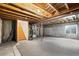 Unfinished basement space with exposed beams, concrete walls, and a window for natural light at 11825 Meadowood Ln, Parker, CO 80138
