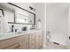 Bathroom with double sinks, modern fixtures, and a large mirror above the vanity at 11825 Meadowood Ln, Parker, CO 80138