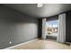 Bedroom featuring modern gray walls, wood floors, and a bright window with curtains at 11825 Meadowood Ln, Parker, CO 80138