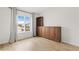Bedroom with wood floors, built-in shelving, and a bright window showcasing the neighborhood at 11825 Meadowood Ln, Parker, CO 80138