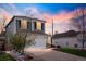 Two-story home with a white two-car garage, complemented by a well-maintained lawn and inviting driveway at 11825 Meadowood Ln, Parker, CO 80138