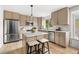 Bright kitchen features white marble countertops, stainless steel appliances, and ample storage space in modern cabinetry at 11825 Meadowood Ln, Parker, CO 80138