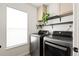 Well-organized laundry room with modern washer and dryer and minimalist shelving at 11825 Meadowood Ln, Parker, CO 80138
