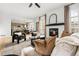 Bright and open living space featuring a fireplace, modern furniture, and seamless flow to the kitchen at 11825 Meadowood Ln, Parker, CO 80138