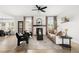 Bright living room featuring a fireplace, modern furnishings, and large windows with natural light at 11825 Meadowood Ln, Parker, CO 80138