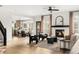 Bright living room features a fireplace, light wood floors, and a seamless flow to the kitchen and dining area at 11825 Meadowood Ln, Parker, CO 80138