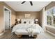 Stylishly decorated main bedroom with bench, featuring a large window with natural light at 11825 Meadowood Ln, Parker, CO 80138