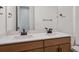 Modern bathroom featuring double sinks, sleek fixtures, and wood cabinets at 4729 Twelve Oaks Way, Castle Rock, CO 80104