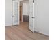 Bright bedroom with wood-look flooring, open french doors and neutral decor at 4729 Twelve Oaks Way, Castle Rock, CO 80104