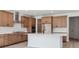 Bright kitchen with wood cabinets, stainless steel appliances, and a large island with quartz countertops at 4729 Twelve Oaks Way, Castle Rock, CO 80104