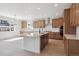 Light filled kitchen with wood cabinets, stainless steel appliances, and a large island with quartz countertops at 4729 Twelve Oaks Way, Castle Rock, CO 80104