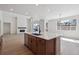 Spacious kitchen with stainless appliances, wooden cabinets, island and views to the living room at 4729 Twelve Oaks Way, Castle Rock, CO 80104