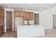 Stylish kitchen with stainless steel appliances, pantry, light wood cabinets, island and quartz countertops at 4729 Twelve Oaks Way, Castle Rock, CO 80104