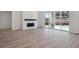 Bright living room featuring a fireplace and sliding doors leading to the backyard at 4729 Twelve Oaks Way, Castle Rock, CO 80104