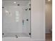 Modern bathroom showcasing a glass-enclosed shower with white tile and black hardware at 4729 Twelve Oaks Way, Castle Rock, CO 80104