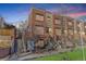 Brick townhouse boasts a well-maintained lawn and a charming exterior, perfect for urban living at 2311 Decatur St, Denver, CO 80211