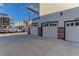 Attached garages featuring white doors and brick accents, providing convenient parking at 2311 Decatur St, Denver, CO 80211