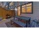 Cozy patio area with outdoor dining table, bench, and string lights for a relaxing ambiance at 2311 Decatur St, Denver, CO 80211