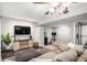 Finished basement boasts a cozy seating area with a large sectional sofa and a mounted TV for entertainment at 11681 Night Heron Dr, Parker, CO 80134
