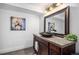 Stylish bathroom with a modern sink, dark wood cabinets, and decorative mirror at 11681 Night Heron Dr, Parker, CO 80134