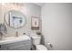 Powder room featuring modern fixtures, decorative mirror, and stylish accents at 11681 Night Heron Dr, Parker, CO 80134