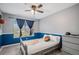 Bedroom with unique basketball decor, a ceiling fan, and large window with ample natural light at 11681 Night Heron Dr, Parker, CO 80134