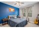 Cozy bedroom featuring calming blue walls, a large window, and stylish decor for a peaceful atmosphere at 11681 Night Heron Dr, Parker, CO 80134