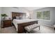 This is a primary bedroom featuring a large bed, bedside tables, and a gray bench at 11681 Night Heron Dr, Parker, CO 80134