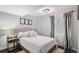 Well-lit bedroom features a comfortable bed, stylish curtains, and a bedside table with a lamp at 11681 Night Heron Dr, Parker, CO 80134