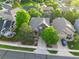 Aerial view of a well-maintained two-story home with mature trees, a spacious yard, and a two car driveway at 11681 Night Heron Dr, Parker, CO 80134