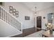 Bright foyer features hardwood floors, staircase, and modern decor at 11681 Night Heron Dr, Parker, CO 80134