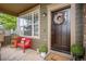 Cozy front porch with a red bench and decorative wreath on the front door at 11681 Night Heron Dr, Parker, CO 80134