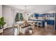 Eat-in kitchen features a dining table with bench seating, custom blue cabinetry, and backyard view at 11681 Night Heron Dr, Parker, CO 80134