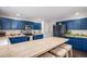 Bright kitchen with blue cabinetry, tiled countertops, and stainless steel appliances at 11681 Night Heron Dr, Parker, CO 80134