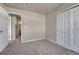 Neutral bedroom with carpet, neutral walls and a closet with bi-fold doors at 12833 Mayfair Way # F, Englewood, CO 80112