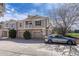 Attractive townhome exterior with stone accents, attached garages, and manicured landscaping at 12833 Mayfair Way # F, Englewood, CO 80112