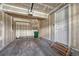An unfinished single car garage with shelves, door to house with concrete floor at 12833 Mayfair Way # F, Englewood, CO 80112