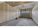 An unfinished single car garage with door to house with concrete floor at 12833 Mayfair Way # F, Englewood, CO 80112