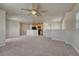 Open living room with neutral carpeting and a view into the kitchen at 12833 Mayfair Way # F, Englewood, CO 80112
