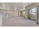 Open living space with a ceiling fan, neutral carpet, and sliding glass doors to a deck at 12833 Mayfair Way # F, Englewood, CO 80112